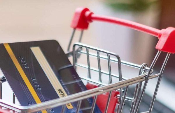 Shopping cart and credit card on laptop at home office. business, e-business, technology, e-commerce, digital banking and online payment concept